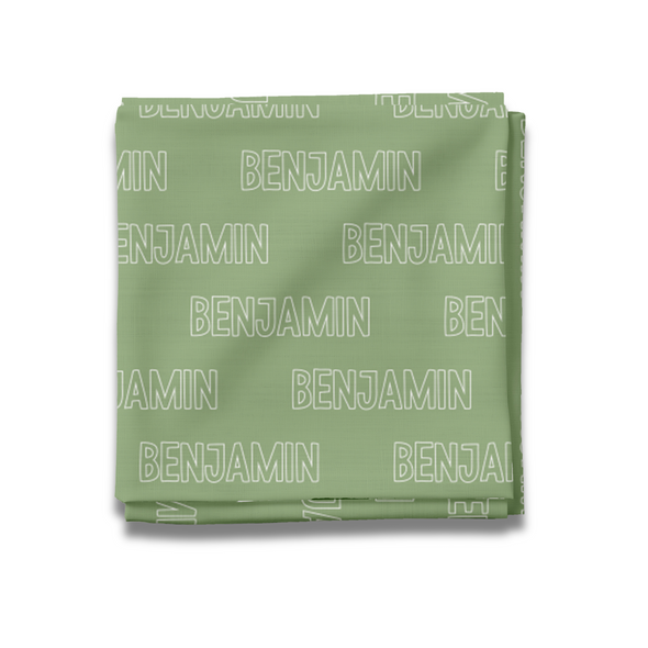 a green blanket with the words benjam printed on it