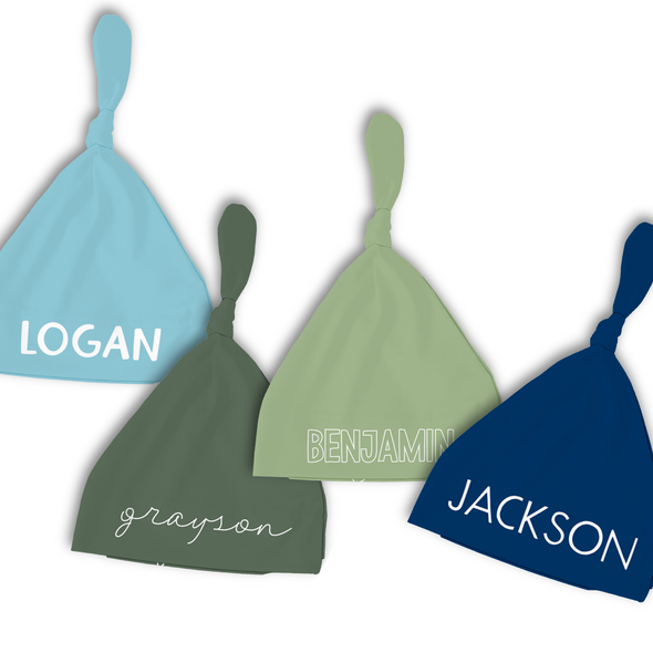 a group of three hats with names on them