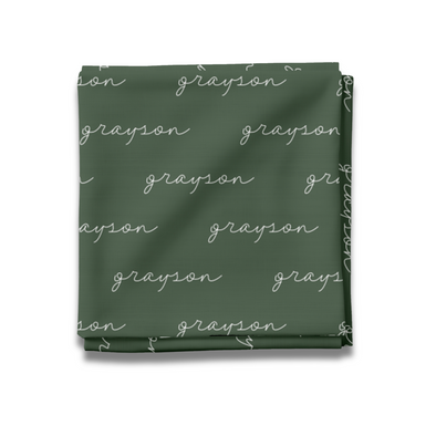 a green blanket with white writing on it