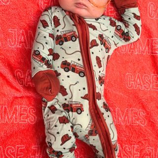 a baby is laying on a red blanket