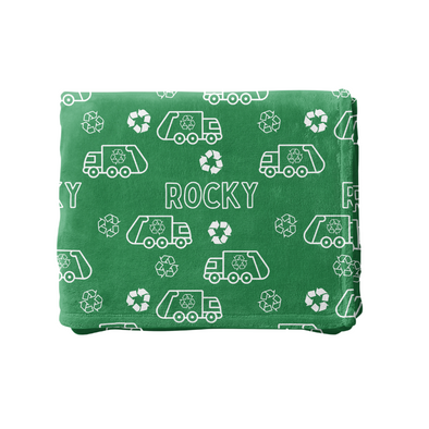 a green and white blanket with cars on it