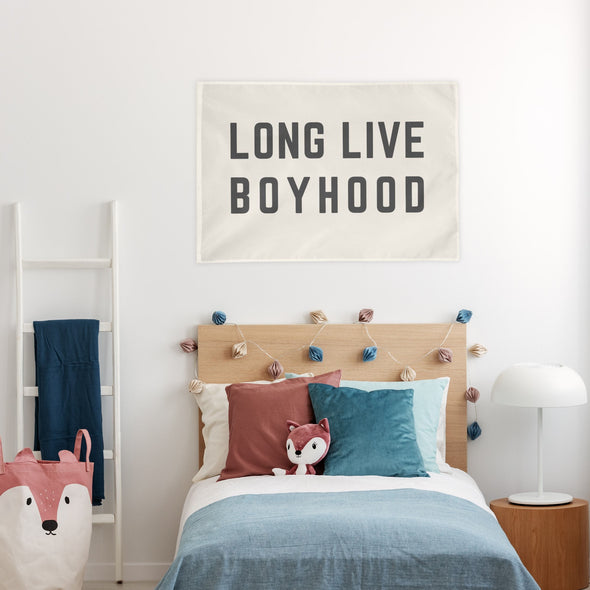"long live boyhood" wall flag hanging over a bed in a child's room
